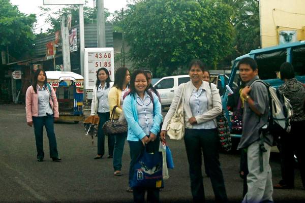 HITCHHIKERS. Teachers wait for vehicles in Calinan to give them a free ride on their way to  Marilog district. These teachers hope to hitchhike everyday to save on transportation expenses, which could cost them P100 roundtrip. MindaNews Photo by Ruby Thursday More