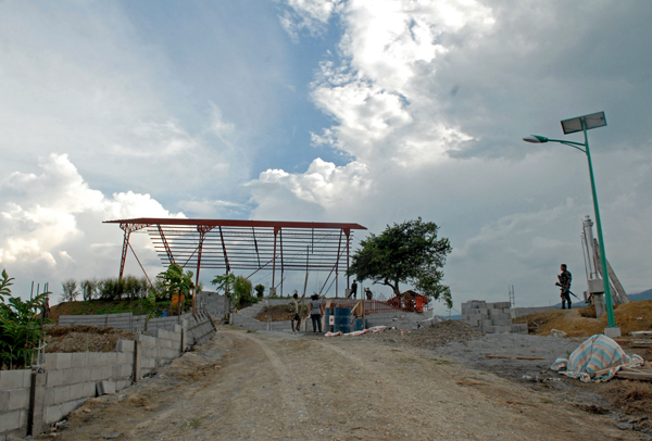 Steel frames, grills and solar-powered lamps are being installed at the site of the Ampatuan Massacre when reporters visited the area Nov. 5. Last year, a "multi-purpose hall" made of coco lumber and GI sheets were constructed on the same site for the first anniversary rites. But by September 2011, less than half of the GI sheets were left. MindaNews photo by Toto Lozano