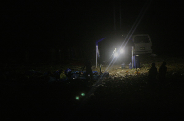 DUMPED. A portable lamp installed in pitch-dark landfill in Sitio Zayas, Barangay Carmen in Cagayan de Oro City at about 11:40 p.m., December 19.. Relatives whose loved ones have been missing since the December 17 flash floods have to go to the city's dumpstie to search for their loved ones. The act of dumping the dead has earned condemnation for this "City of Golden Friendship." MindaNews photo by Toto Lozano.