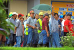 NOISE BARRAGE. A worker flashes a V sign as he joins co-workers in staging a noise barrage in front of the administration office of the Pacific Cement Philippines Inc., in Kilomter 11, Surigao City . January 12, to urge management to release benefits due them. MindaNews photo by Roel N. Catoto