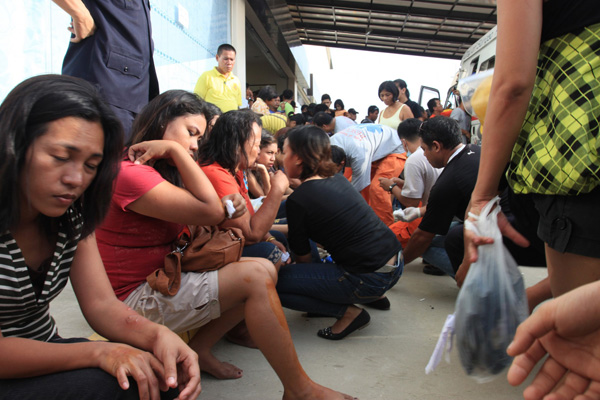 Dozens of victims line up outside Gaisano Capital in Surigao City to get first aid treatment by doctors and medical staff while waiting for ambulances. A stampede occurred as a result of a 5.9-magnitude quake that hit the city on Friday afternoon, March 16, 2012. MindaNews photo by Roel N. Catoto