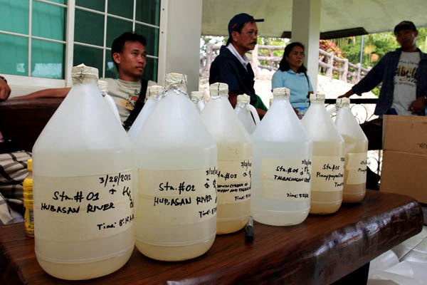 SAMPLES. Gallons containing water samples from Parang-parang watershed in Surigao City are collected by environment agencies on March 28, 2012 to check if creeks and rivers in the watershed contain mercury. MindaNews photo by Roel Catoto