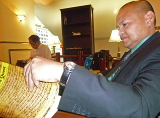 MASTURA'S BOOK. Government peace panel chair Marvic Leonen flips through the pages of "Bangsamoro Quest: The Birth of the Moro Islamic Liberation Front" written by Datu Michael Mastura, senior member of the Moro Islamic Liberation Front peace panel. Leonen and his panel members were given copies of the book inside the negotiations venue at the Palace of the Golden Horses hotel in Kuala Lumpur Monday morning. MindaNews photo by Carolyn O. Arguillas