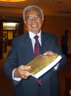 MASTURA'S BOOK. Datu Michael Mastura, senior member of the Moro Islamic Liberation Front peace panel, shows his book, "Bangsamoro Quest: The Birth of the Moro Islamic Liberation Front" shortly before entering the venue for the peace negotiations with the Philippine government at the Palace of the Golden Horses hotel in Kuala Lumpur, Monday. The book, published in Penang,  will be launched at the Universiti Sains Malaysia there on May 31. MindaNews photo by Carolyn O. Arguillas