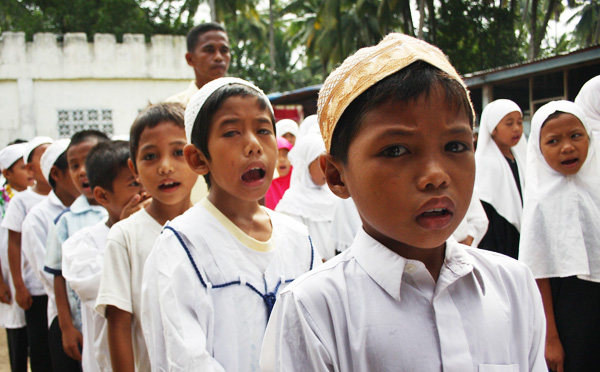 Students sing the "Allah Hugaya Tunah" hymn before the start of the closing rites at the madrasah in Barangay Cuyapon, Kabacan, North Cotabato on July 4, 2012. MindaNews Photo by Ruby Thursday More