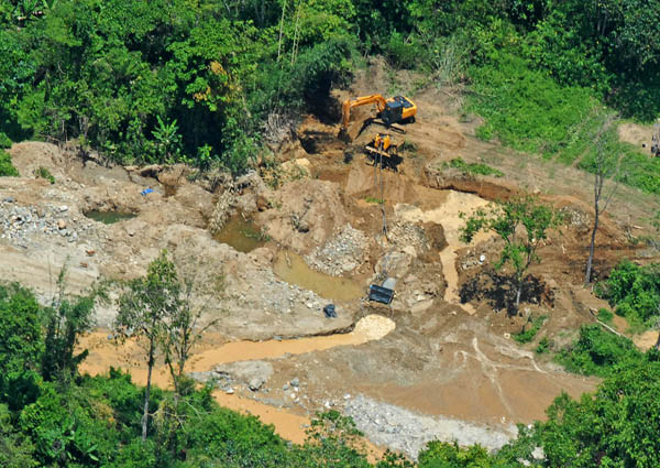 hilippine Air Force choppers sent to investigate illegal mining operations along Iponan River in Cagayan de Oro City on Sept. 21, 2012 spotted this payloader heavy equipment tearing away the river banks. MindaNews photo by Froilan Gallardo