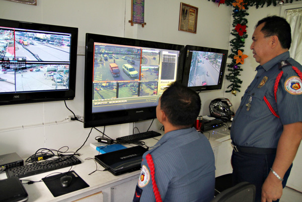 WE'RE WATCHING. Sr. Supt. Nerio Bermudo (right), Butuan City police director, checks footages of the eight CCTV cameras at the monitoring center at the Butuan City Police Office last November 8, 2012. Several more cameras are up for installation to help in the city's crime prevention campaign. Mindanews Photo by Erwin Mascarinas