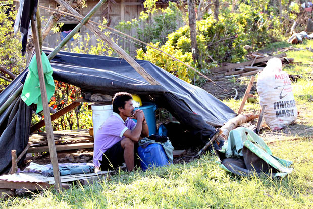 ONE-MILE-STARE. A resident sits by a tent he had set up after his house was destroyed by Typhoon Pablo in Veruela town, Agusan del Sur on Dec. 6, 2012. MindaNews photo by Erwin Mascarinas