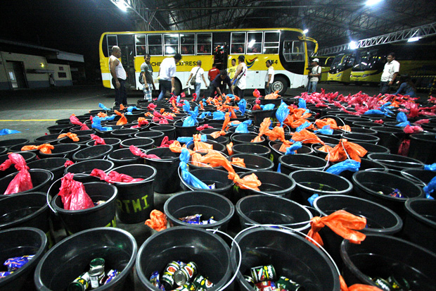 Workers of Bachelor Express and Rural Transit Mindanao bus lines load relief goods onto a bus on Monday night, December 17 at their headquarters in Maa, Davao City. The relief goods–consisting of pails, noodles, sardines, medicines and rice–will be delivered today, December 18 to typhoon stricken areas in Compostela Valley and Davao Oriental Provinces. MindaNews Photo by Ruby Thursday More