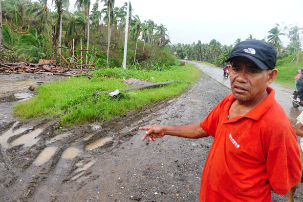 NOTHING LEFT. Aurelio Pescadio, 58, shows where his shop once stood in Trento, Agusan del Sur on Dec. 21. 2012. The shop of Pescadio sells bukag along the highway. MindaNews photo by Bong S. Sarmiento