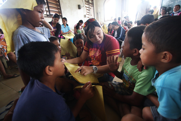 PSYCHOSOCIAL PROCESSING. A psychologist from the Center for Psychological Extension and Research Services (COPERS) of the Ateneo de Davao University interacts with one of the young survivors of Typhoon Pablo in New Bataan, Compostela Valley Province on Thursday, 27 December 2012 during a psychosocial processing with children of Purok 4. . COPERS' affiliates from Xavier University in Cagayan de Oro were part of the team. . MindaNews Photo by Ruby Thursday More