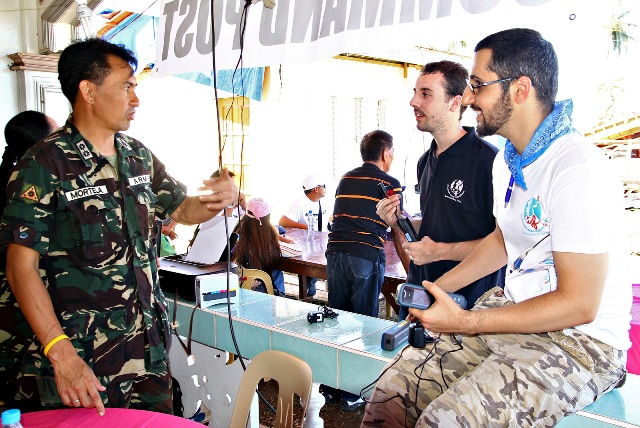CONNECTED. Lt. Col. Krishnamurti Mortela, chief of the 67th Infantry Battalion in Baganga, Davao Oriental, asks Telecoms Sans Frontieres experts Sebastien Latouille and Tylor on how the emergency telecommunications system works and how much it cost on Tuesday afternoon. MindaNews photo by Erwin Mascarinas
