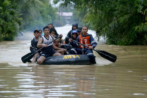 Philippine Navy rescuers navigate through the flooded road as they transport rescued residents from Jade Valley subdvision in Brgy Buhangin, Davao City on January 20. Mindanews Photo by Keith Bacongco