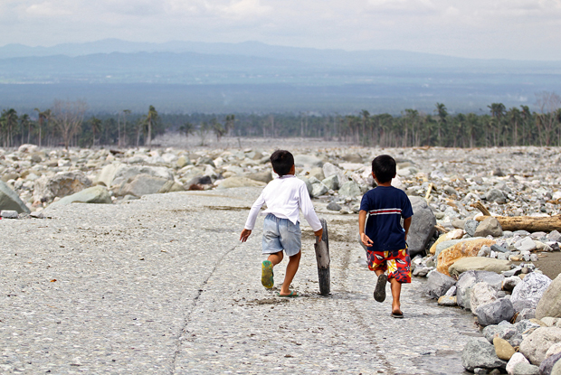 BOYS WILL BE BOYS. Boys find time to play on 28 Jan 2013 amid the destruction caused by Typhoon Pablo in Barangay Andap, New Bataan, Compostela Valley. MindaNews photo by Erwin Mascarinas