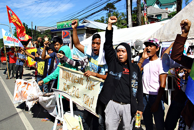 Some 400 protesters barricade the gate of Mines and Geosciences Bureau regional office in Surigao City Friday afternoon. The protest which started last March 11 stemmed from the refusal of the MGB to enforce a court order preventing the MarcVentures Mining Development Corporation from operating in a watershed in Cantilan, Surigao del Sur. Mindanews Photo by Erwin