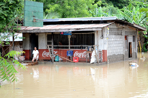 A villager wades through the floodwater in Barangay Kayaga, Kabacan, North Cotabato on Saturday. Gov. Emmylou Taliño-Mendoza said a total of 10,270 families were affected by floods that submerged 26 villages in the towns of Carmen, Kabacan, Matalam, Mlang, President Roxas and Tulunan when rivers overflowed starting Friday evening. Photo courtesy of PDRRMO / North Cotabato