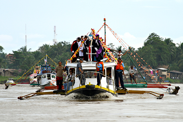 An image of Saint Anne stands on the roof of the lead boat as it cruises along the Agusan River during the Abayan Festival fluvial procession in Butuan City last july 28, 2013. MindaNews photo by Erwin Mascarinas