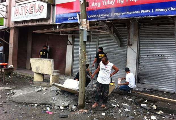 An Explosives Ordnance Team from the Phlippine Army gathers evidence at the explosion site on the ground floor of a building in downtown Midsayap, North Cotabato. There were no reported casualties. Photo courtesy of Karl Ballentes