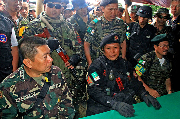 FRIENDS. MILF commander Abdurahman Macapaar, aka Kumander Bravo (center), and Col. Glen Macasero, commanding officer of the 103rd Infantry Brigade (left) during a press conference inside the rebel Camp Watu in Barangay Barit, Balindong town in Lanao del Sur Monday, Sept. 9. The MILF has allowed the Philippine Army to search their camps in Lanao del Sur following allegations that they were harboring terror groups responsible for the series of bombings in Cagayan de Oro City and other parts of Mindanao. No terror suspects were found in the camps. Mindanews Photo