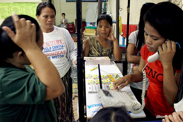 FREE CALL. Evacuees make free calls to their loved ones at the Surigao City Auditorium on Thursday afternoon Nov. 7, 2013, courtesy of a telecommunication company. MindaNews photo by Roel N. Catoto