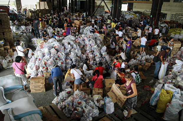 At least 1500 volunteers troop to the Department of Public Works and Highway (DPWH) depot on Saturday, Nov. 16, 2013, to help in the repacking of relief goods for the survivors of super typhoon Yolanda in the Visayas. MindaNews photo by Keith Bacongco