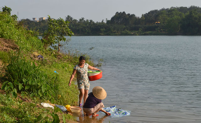 Hue women do their laundry at the Perfume River. MindaNews photo by Lorie Ann Cascaro