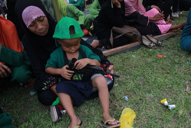 MY BOY. Sarah Ibod attends to her son. Mujahid, in the MILF"s  Camp Darapanan, Sultan Kudarat, Maguindanao province to join hundreds in celebrating the signing of the Comprehensive Agreement on the Bangsamoro on March 27, 2014. MindaNews photo by Toto Lozano