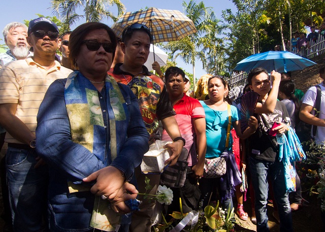 Justice Secretary Leila de Lima offers her prayers to the victims of the Ampatuan massacre during the 5th year commemoration in Barangay Salman, Ampatuan town in Maguindanao on November 23, 2014. MindaNews photo by Toto Lozano