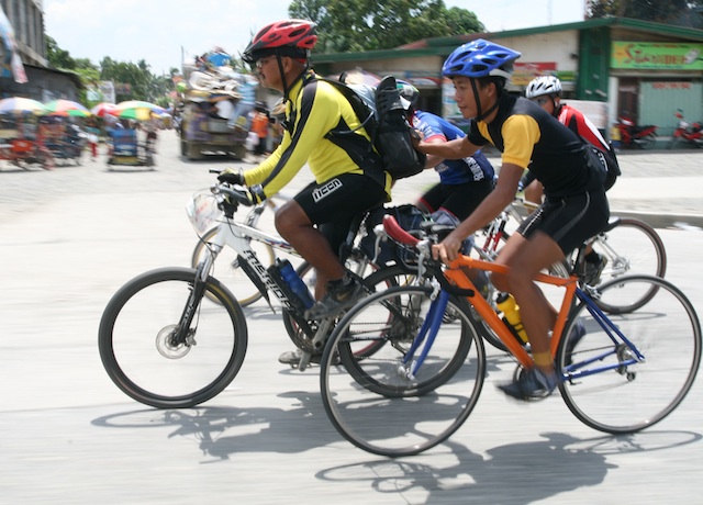 Redemptorist priest Amado "Picx" Picardal (in yellow jersey) assisted by local bikers along the national highway in Panabo City on May 18,  2008, the last day of his 56-day bike 'for life and peace,' which covered 5, 164 kilometers around the country.  Local bikers accompanied him from Tagum City all the way to Davao City. MindaNews file photo by KEITH BACONGCO