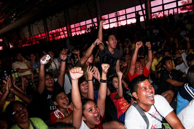 Delegates to the Palarong Pambansa cheer during the Pacquiao-Mayweather fight, which was shown on a giant screen inside the gymnasium at the Davao del Norte Sports Complex in Tagum City on Sunday, May 3. MindaNews photo by Keith Bacongco