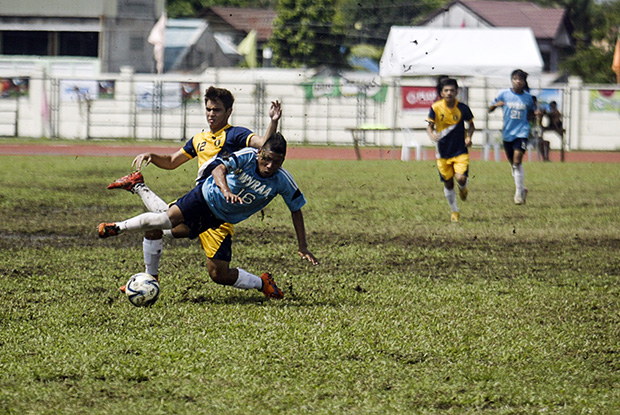 Players fight for the ball in the championship match on Saturday of the secondary football game between National Capital Region and Western Visayas Region during the Palarong Pambansa in Tagum City, Davao del Norte. Western Visayas Region captured its first ever crown in secondary football after a shootout. MindaNews photo by Keith Bacongco