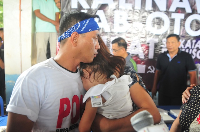 REUNITED. Army Sgt. Adriano Bingil is reunited with wife, Genalyn and their two-year-old daughter, Phoebe, after 104 days in captivity. Bingil was released to Davao City mayor and Presidential aspirant Rodrigo Duterte and the Philippine Ecumenical Peace Platform in Barangay Durian, Las Nieves, Augsan del Norte on New Year’s eve, December 31, 2015. MindaNews photo by Froilan Galla