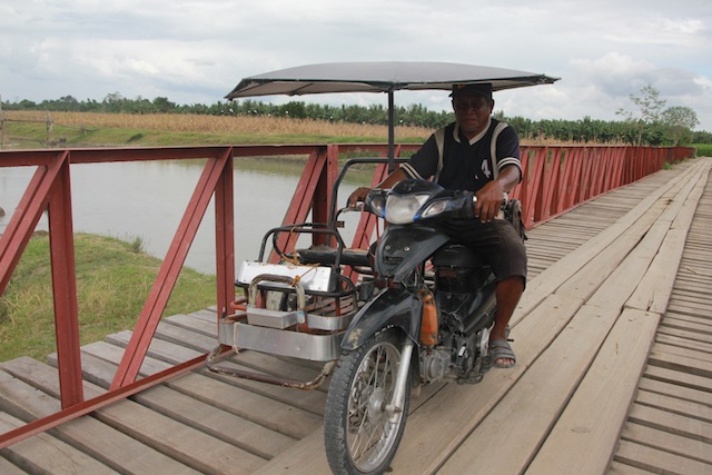 NEW BRIDGE. A tricycle passes through a newly constructed bridge in Barangay Tukanalipao, Mamasapano, Maguindanao province. The bridge makes it easier for residents to ferry their goods to the poblacion. MindaNews photo by TOTO LOZANO 