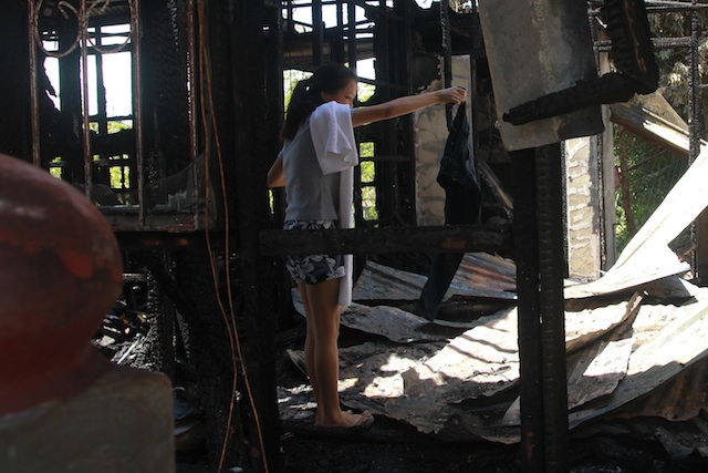College student Rainbe Bartolome tries to salvage what is left of her belongings in Gonzalez Dorm inside UCCP Haran compound, Padre Selga Street, Davao City on February 24, 2015. Several minutes after a fire broke out in the camp where hundreds of Lumads (Indigenous Peoples) are seeking refuge, fire also broke out in the two dormitories where students are staying. Bartome lost her laptop, medical books, and other valuables in the fire. MindaNews photo by TOTO LOZANO