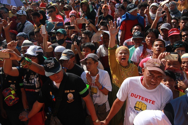 A Moro woman tries to get the attention of the people onstage where presidential candidate and Davao City mayor Rodrigo Duterte delivered his speech at the Cotabato City plaza on Saturday, February 27. MindaNews photo by Toto Lozano 