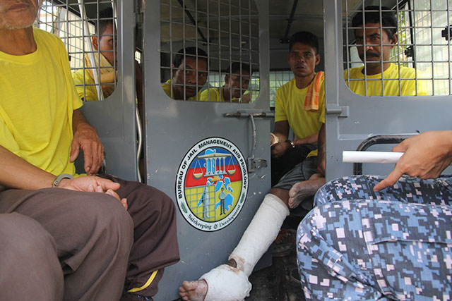 Detained farmer Arnel Takyawan tries to stretch his leg while waiting for their supposed arraignment at the Hall of Justice in Kidapawan City on April 14, 2015. The arraignment was deferred as lawyers questioned the validity of the arrest. Takyawan was hit by a bullet during a violent dispersal of a protest rally last April 1. He was among 81 charged with "direct asssault.". MindaNews photo by TOTO LOZANO 