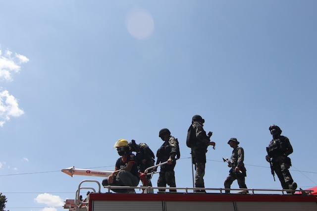 Members of SWAT (Special Weapons and Tactics) team on top of a firetruck in Kidapawan City on March 30, Day 1 of the barricade. MindaNews photo by TOTO LOZANO 