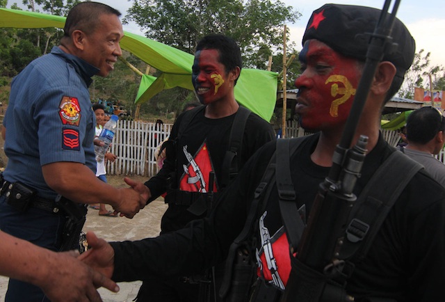 LIKE BROTHERS. A policeman shakes hand with members of the New Peoples Army after the latter released Private First Class Edgardo Hilaga of the 7th Infantry Battallion in Tulunan, North Cotabato on April 26, 2016. Hilaga was captured at a checkpoint in Makilala five days earlier. MindaNews photo by TOTO LOZANO