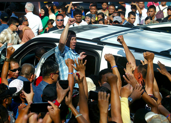 Davao CIty Mayor Rodrigo Duterte, the lone Mindanawon Presidentilal candidate, chants "Allahu Akbar" (Allah is Great) as he arrives at the venue of the Cotabato City rally on February 27. Duterte was warmly welcomed by the Moro people for whom he vowed his administration would "correct the historical injustice" done to them. MindaNews photo by KEITH BACONGCO 