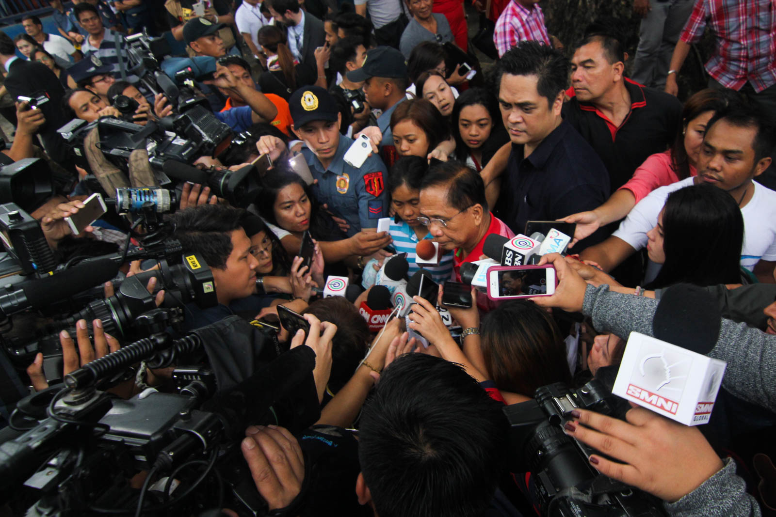Reporters crowd around freed kidnap victim Marites Flor (beside returning Presidential Adviser on the Peace Process Jesus Dureza) as she stepped down from the stage at the Dvao City Police Office parade grounds Friday afternoon, after she was presdented to PResident-elct Rodrigo Duterte, some 12 hours after she was freed by the Abu Sayyaf in Sulu after nine months and three days in captivity. MindaNews photo by TOTO LOZANO