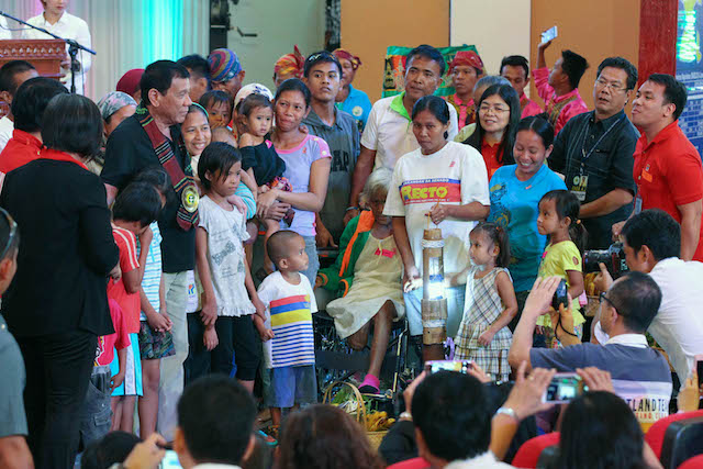 President Rodrigo Dutete poses with beneficiaries of the anti-malnutrition and anti-hunger programs during the launch of the Comprehensive Reform and Development Agenda for Autonomous Region in Muslim Mindanao (ARMM) and other Conflict-Affected Areas in Regions 9, 10, and 12 at Shariff Kabunsuan Cultural Complex in Cotabato City on October 29. SIMEON CELI JR./Presidential Photo 
