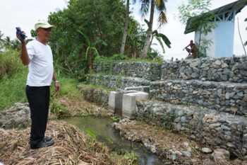 Kagawad Danilo Casa of Brgy. Biwang, Bagumbayan, Sultan Kudarat shows the intake structure with gabions of the solar-powered irrigation project site in his brother’s farm. MindaNews photo by H. MARCOS C. MORDENO